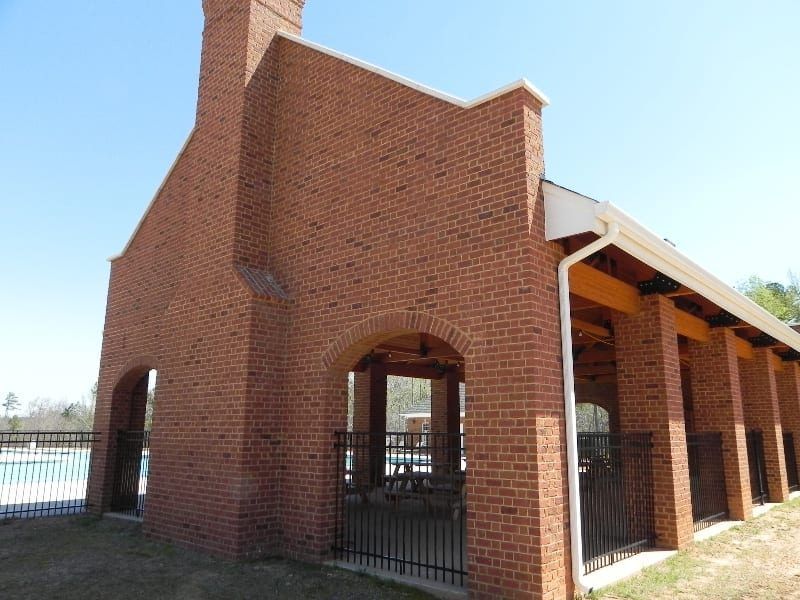 A large brick building with arches and a chimney