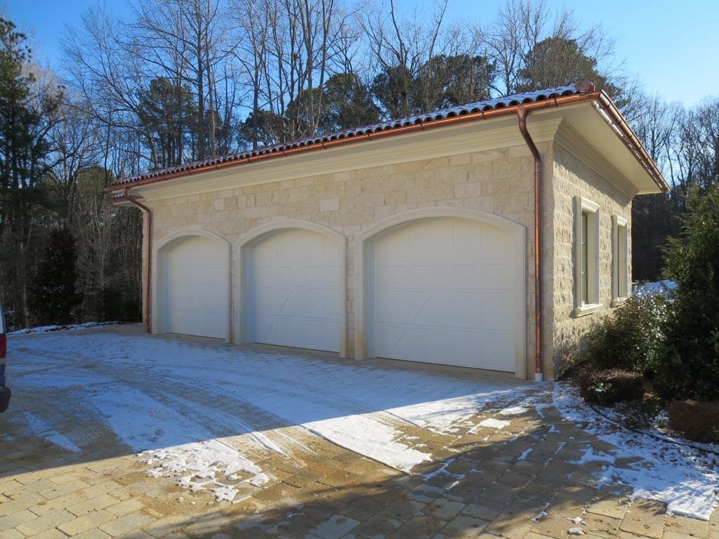 A garage with four doors and a copper roof