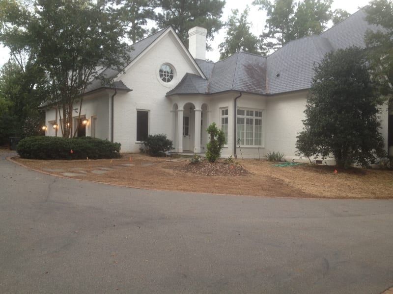 A large white house with a gray roof