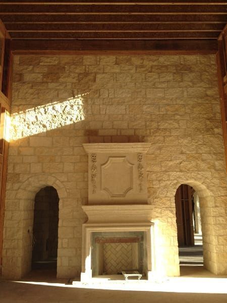 A large room with a fireplace in the middle of it