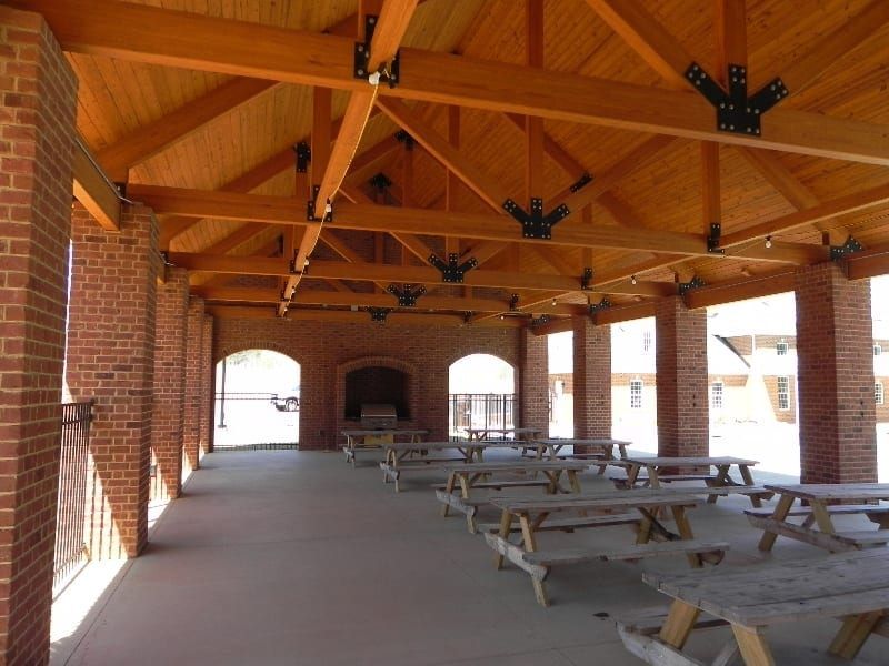 A pavilion with wooden beams and brick pillars