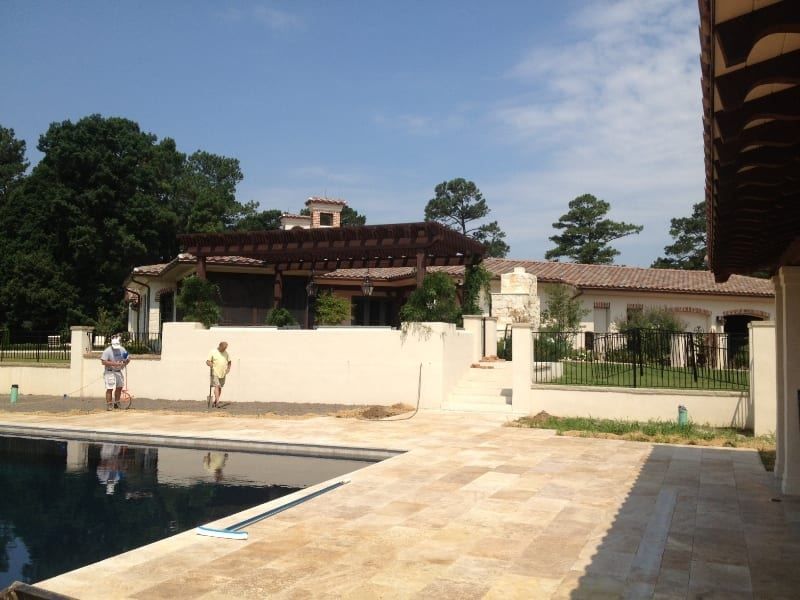 A large house with a swimming pool in front of it