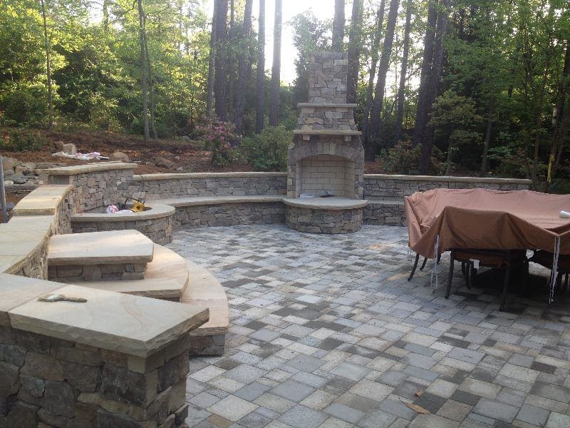 There is a fireplace in the middle of the patio