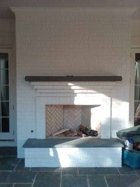 A fireplace with a bench in front of it in a living room