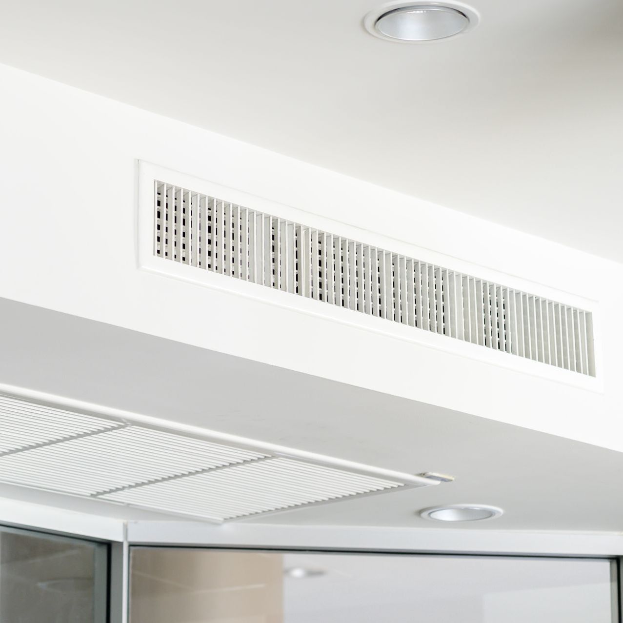 a white ceiling with a ventilation system built into it .
