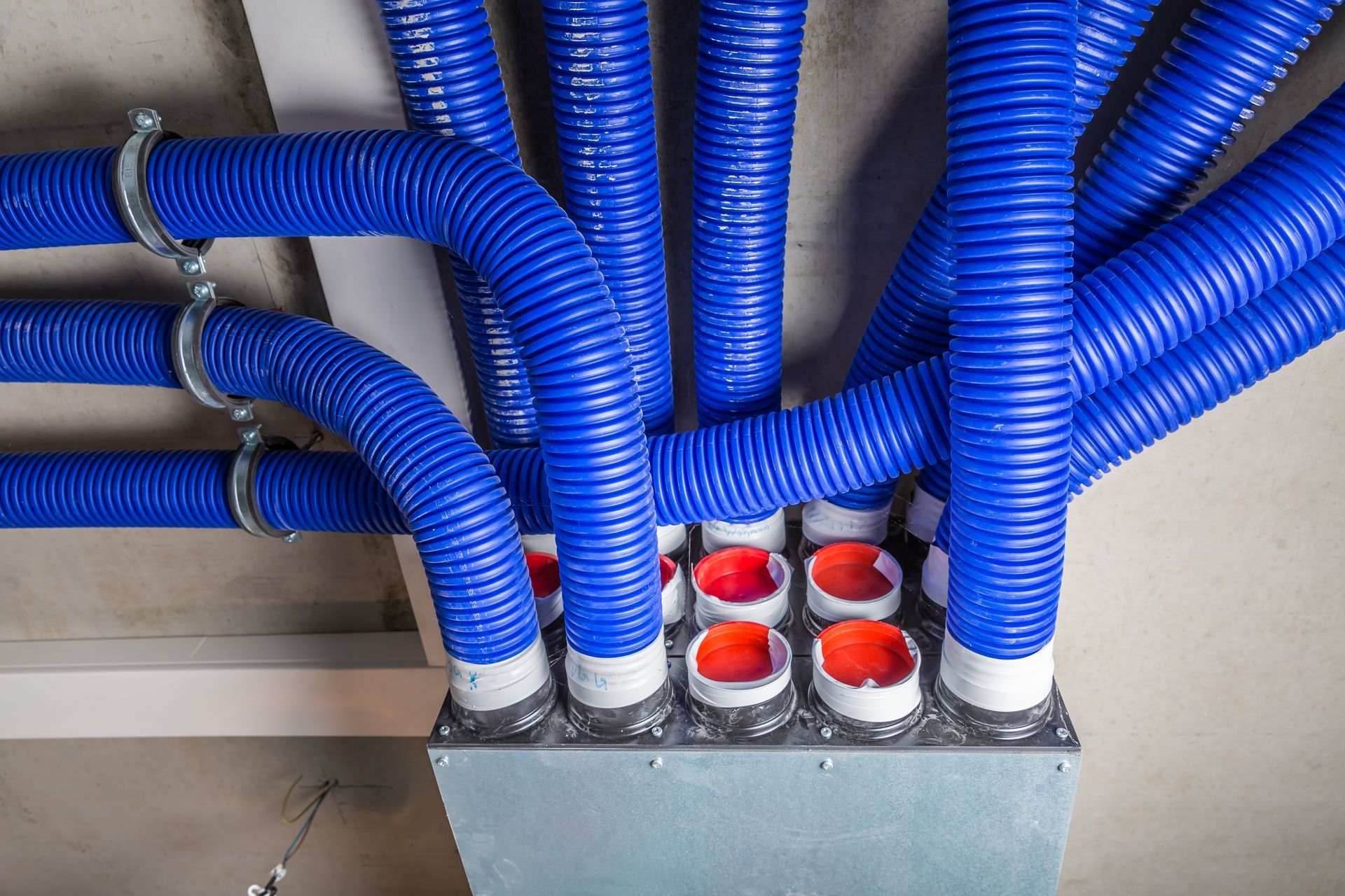 a bunch of blue pipes are connected to a box .