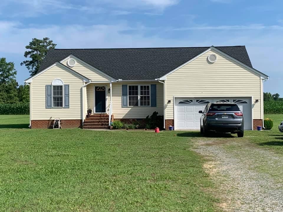 A house with a car parked in front of it.