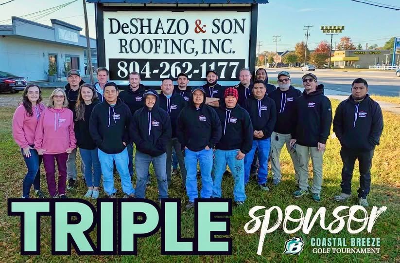 DeShazo & Son Roofing team posing in front of their sign, sponsoring a golf tournament.