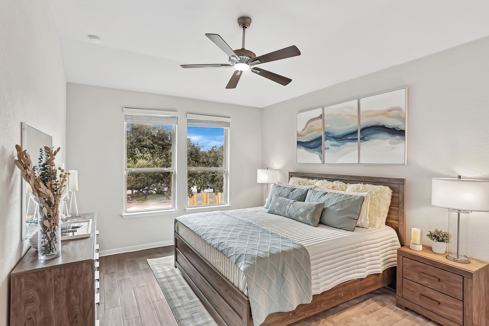 Bedroom with a black metal bed, green bench, and white walls.