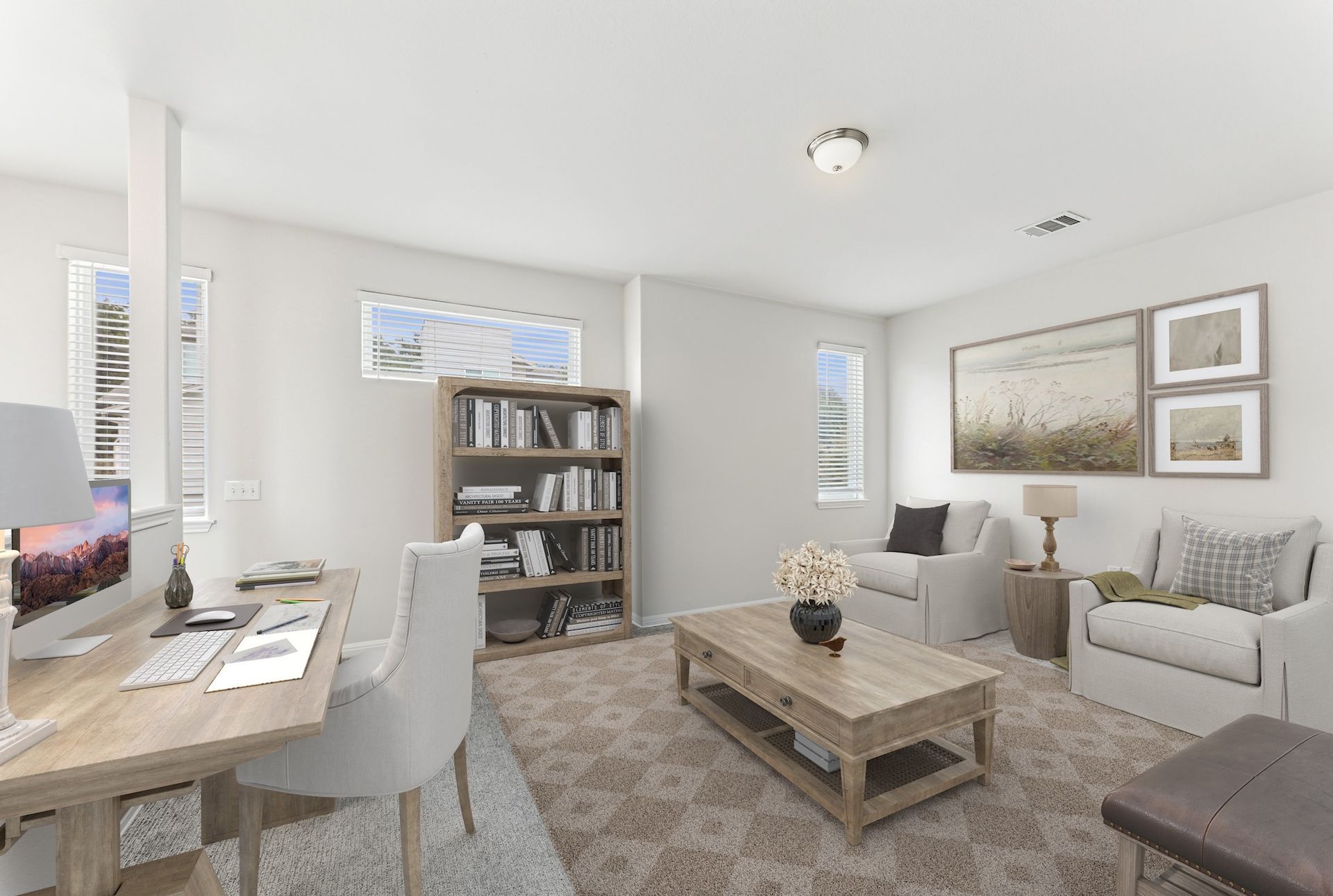 Cozy home office with desk, bookshelves, and seating area featuring neutral tones.