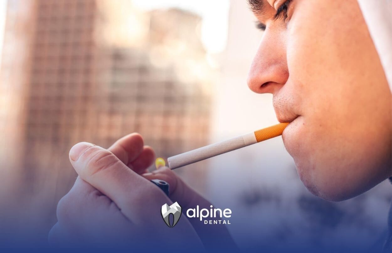 Man lighting a cigarette outdoors.
