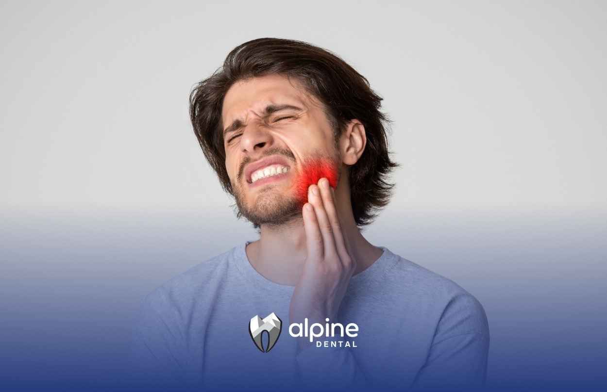 A man is holding his face in pain because of a toothache.