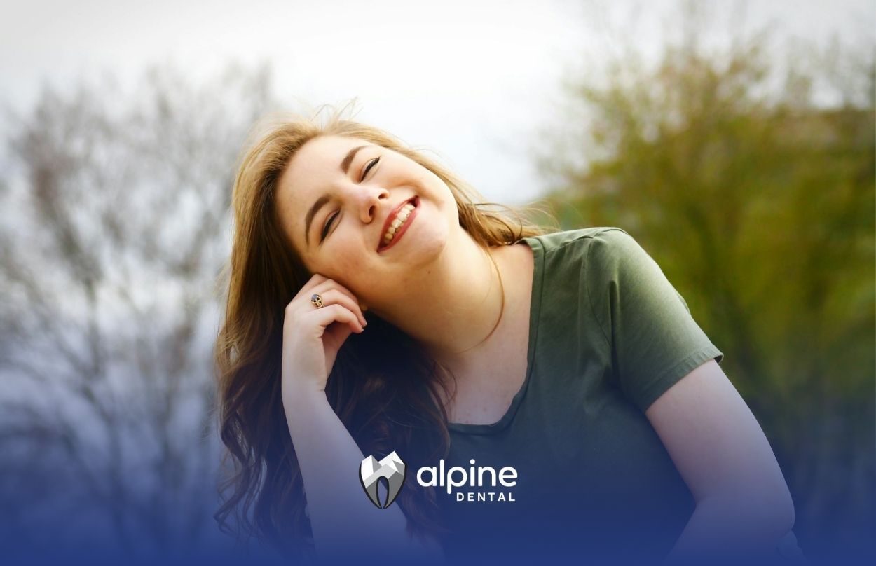 A young woman enjoying a candid moment with a relaxed, cheerful expression outdoors in Lakewood, NJ.