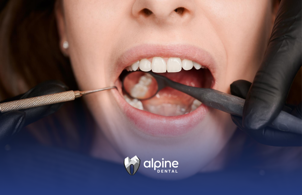 A woman is getting her teeth examined by a dentist.