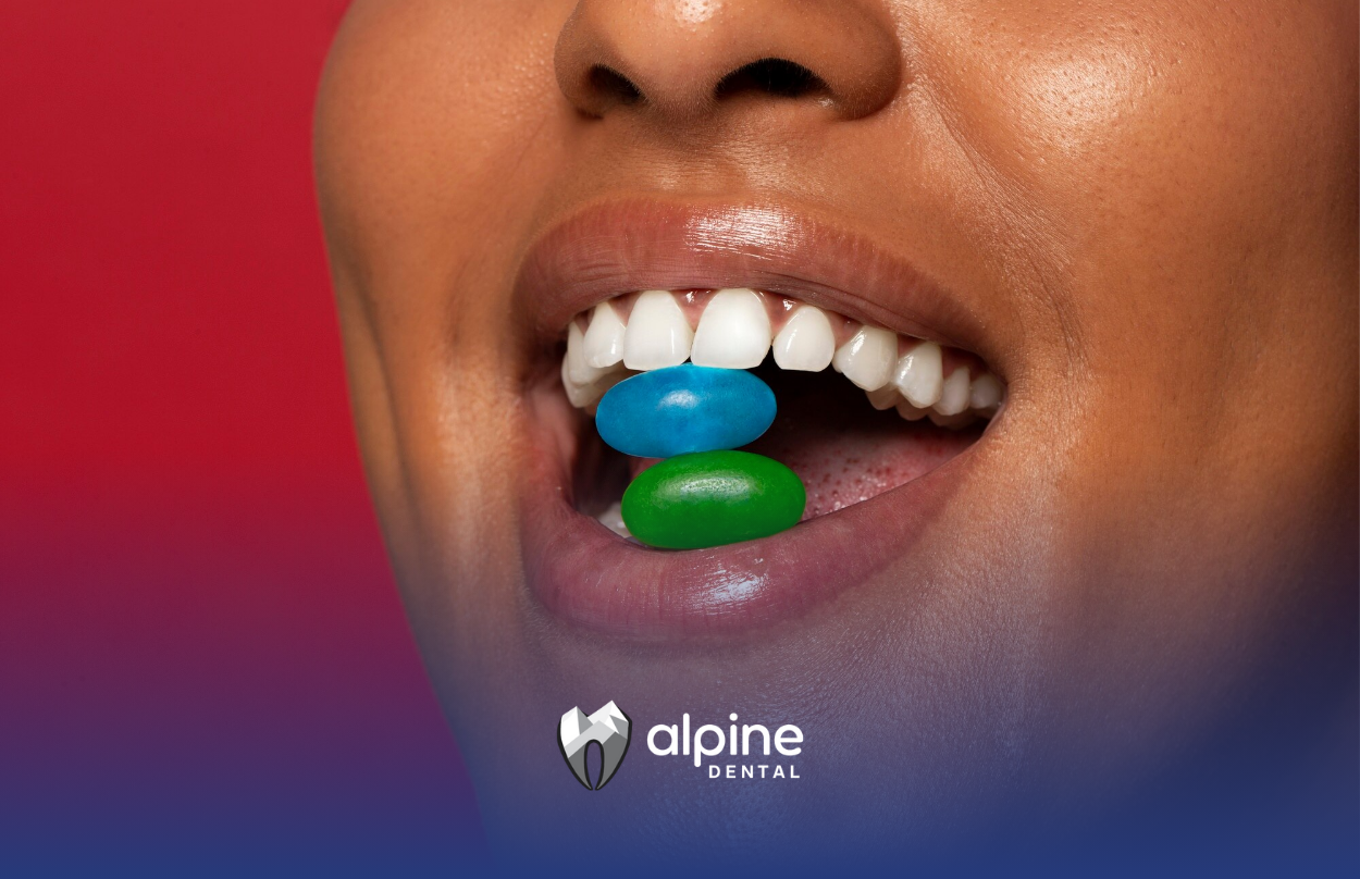 A woman is taking vitamins in her mouth.