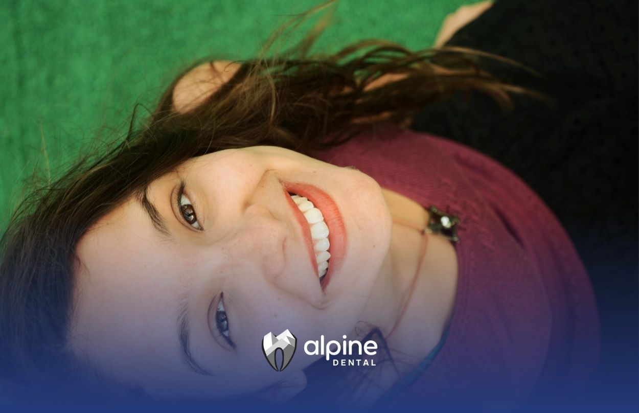Smiling woman showing healthy white teeth after she treats the white spots at a dental clinic in NJ.
