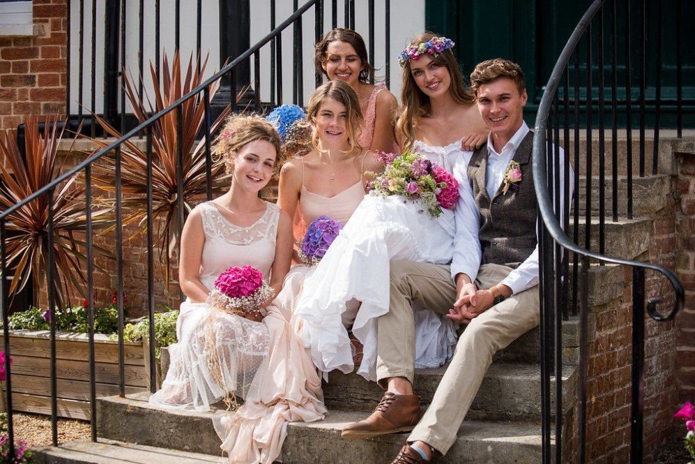Wedding Couple and guests at the stairs into Kennaway House