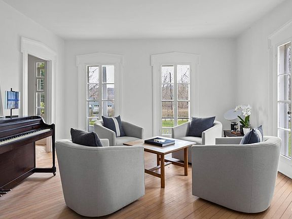 A living room filled with furniture and a piano.