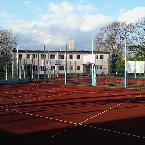 A basketball court with a building in the background