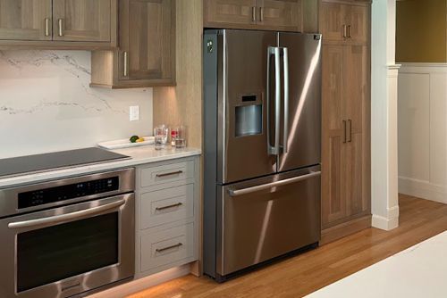 A kitchen with a stainless steel refrigerator , oven , and stove.