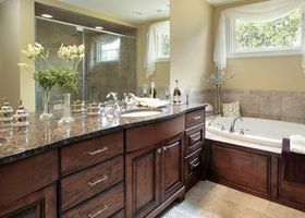 A bathroom with a tub , sink , and mirror.