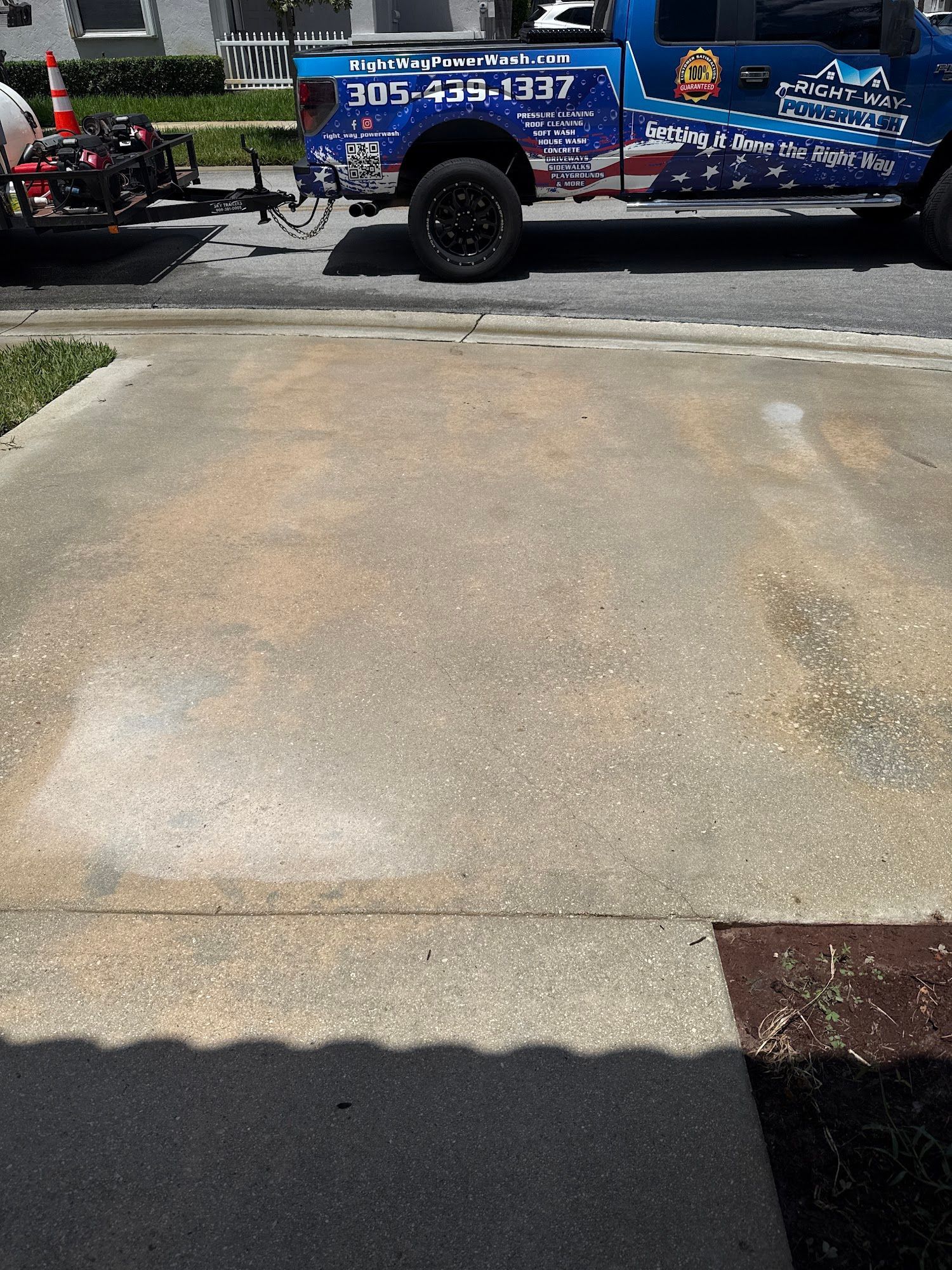 Concrete driveway with truck parked on the side. Shadow on the bottom right.