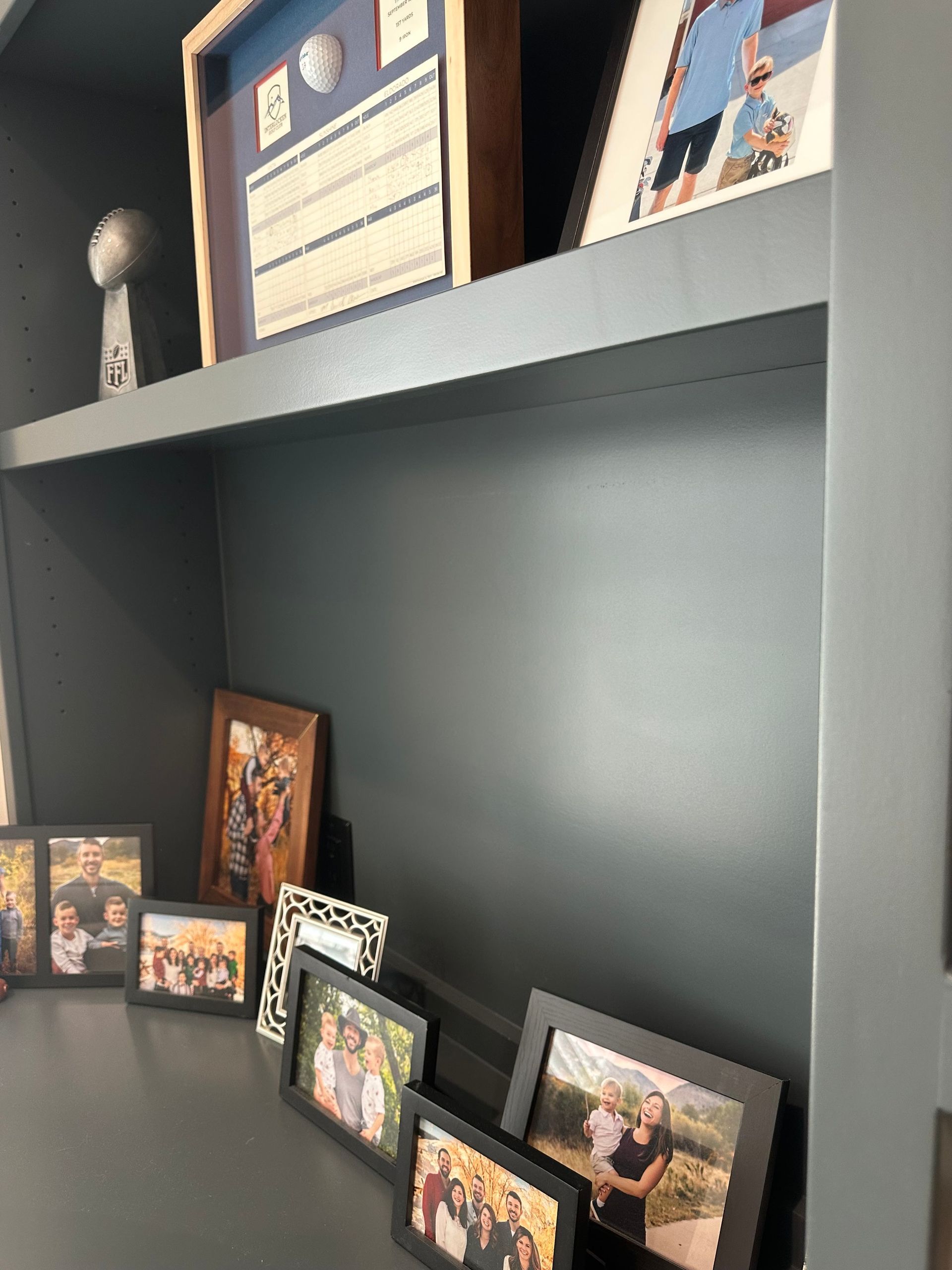 A shelf with a bunch of pictures on it