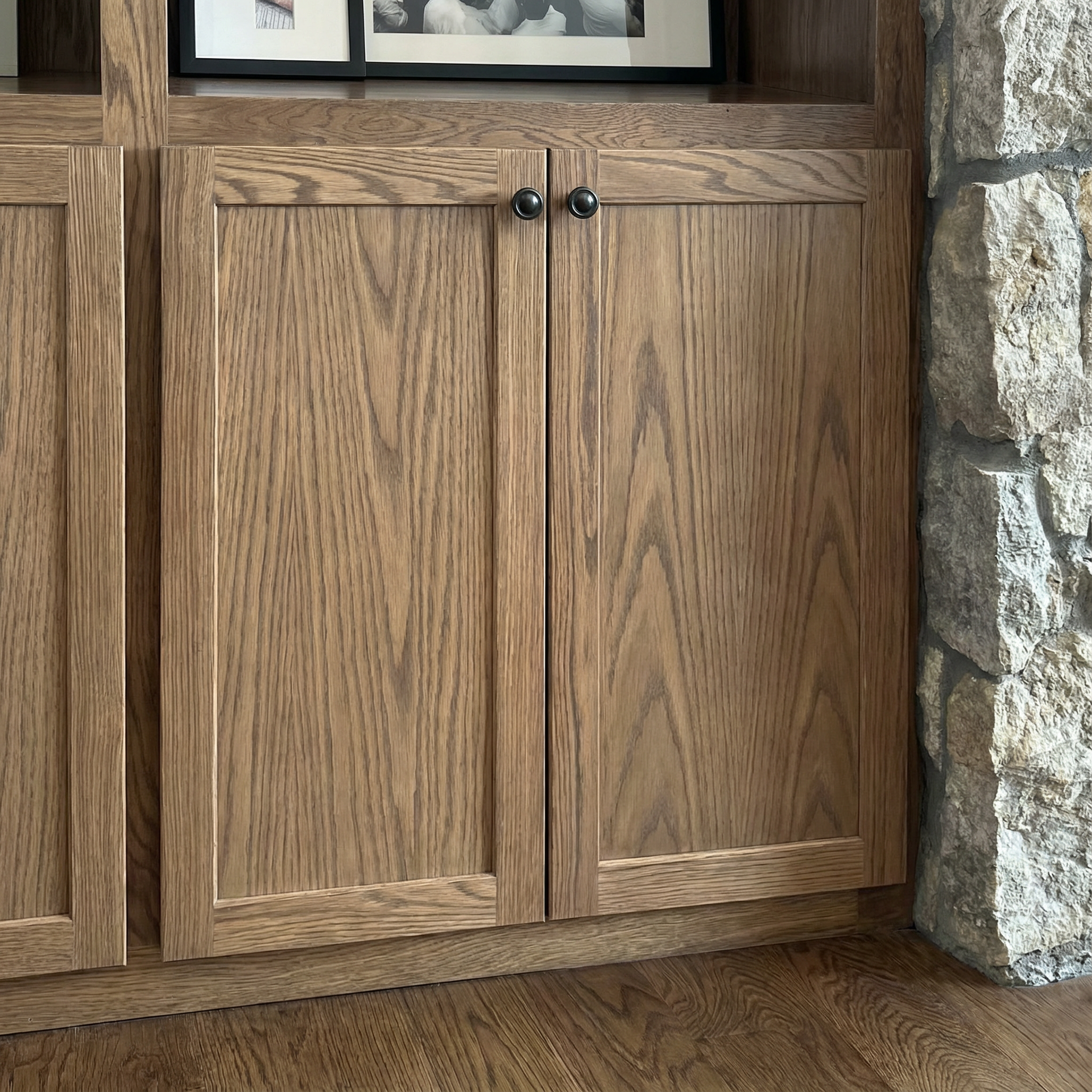 A wooden cabinet with two doors is sitting on a wooden floor.