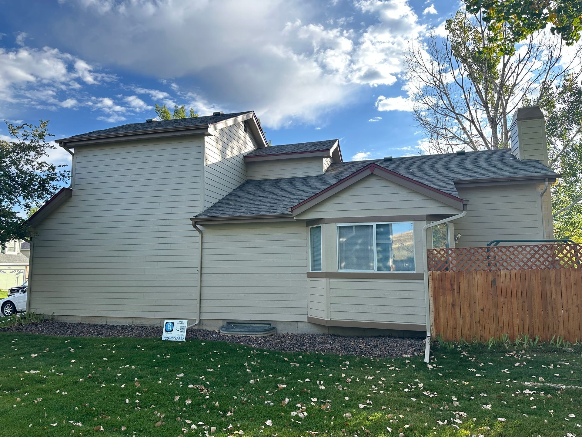 A house with a fence and a sign in front of it.