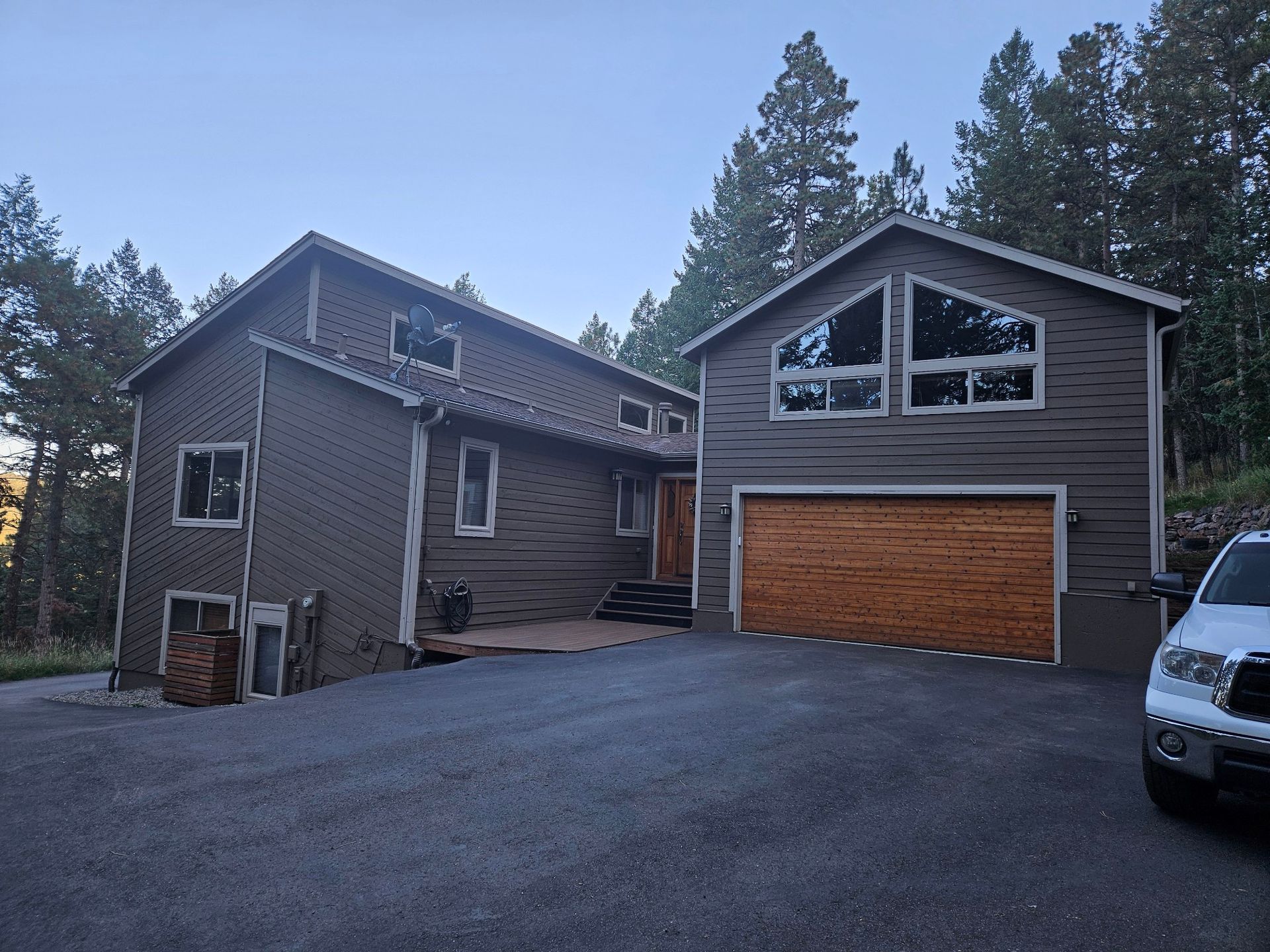 A large house with a car parked in front of it