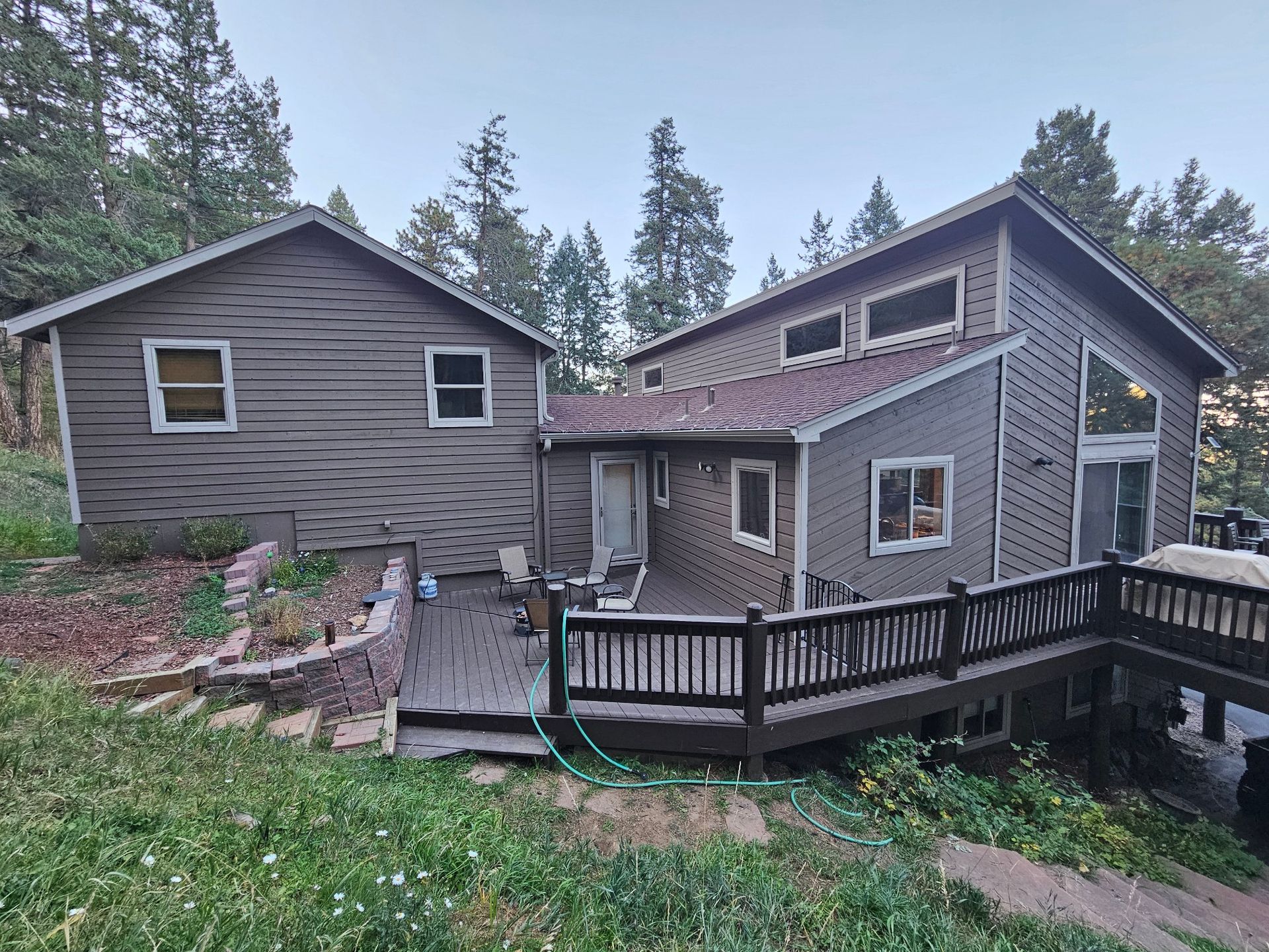 A large house with a large deck and stairs leading up to it.