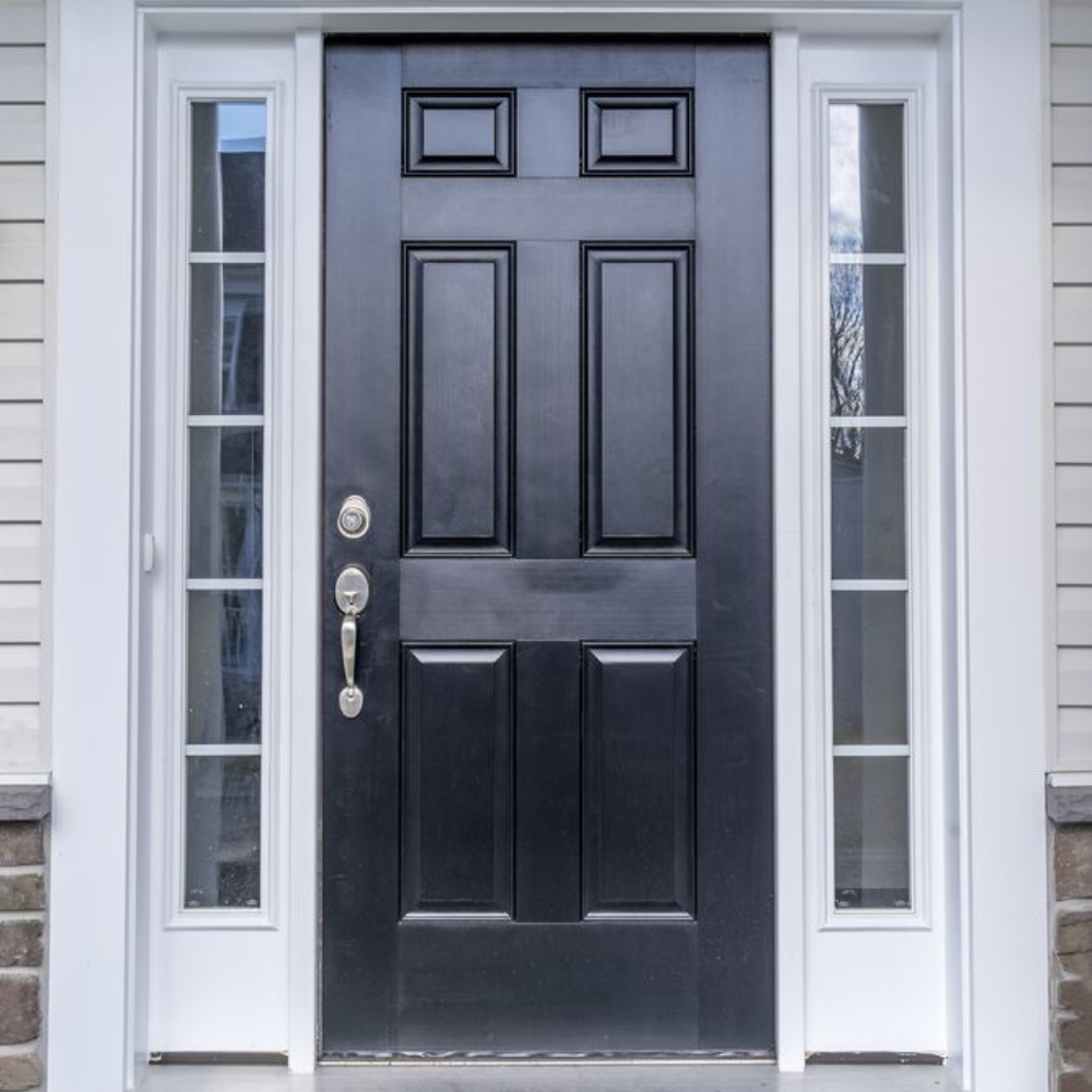 Black front door with sidelight windows, white trim, and a brick and siding exterior.