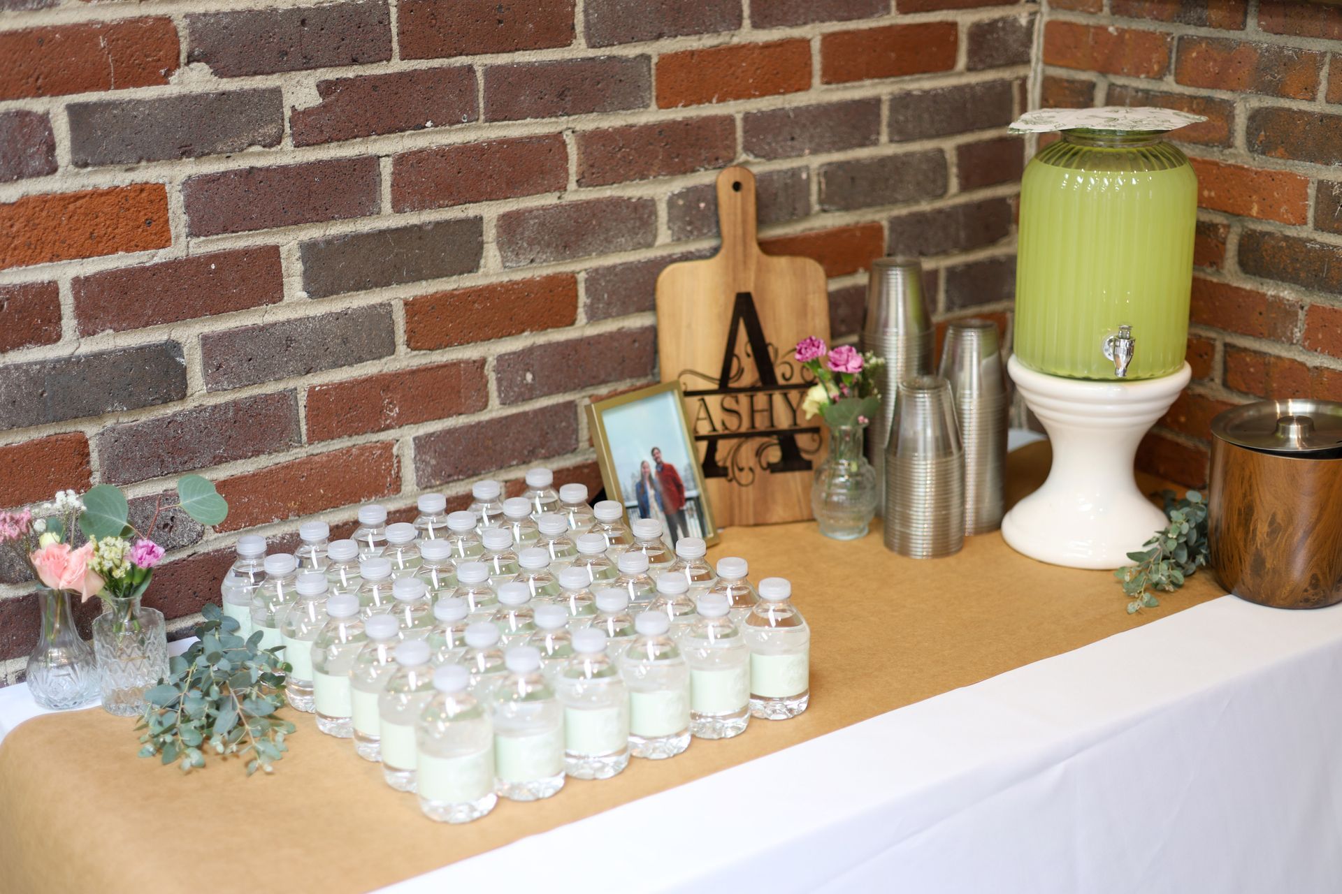 Refreshment station set up against the brick wall