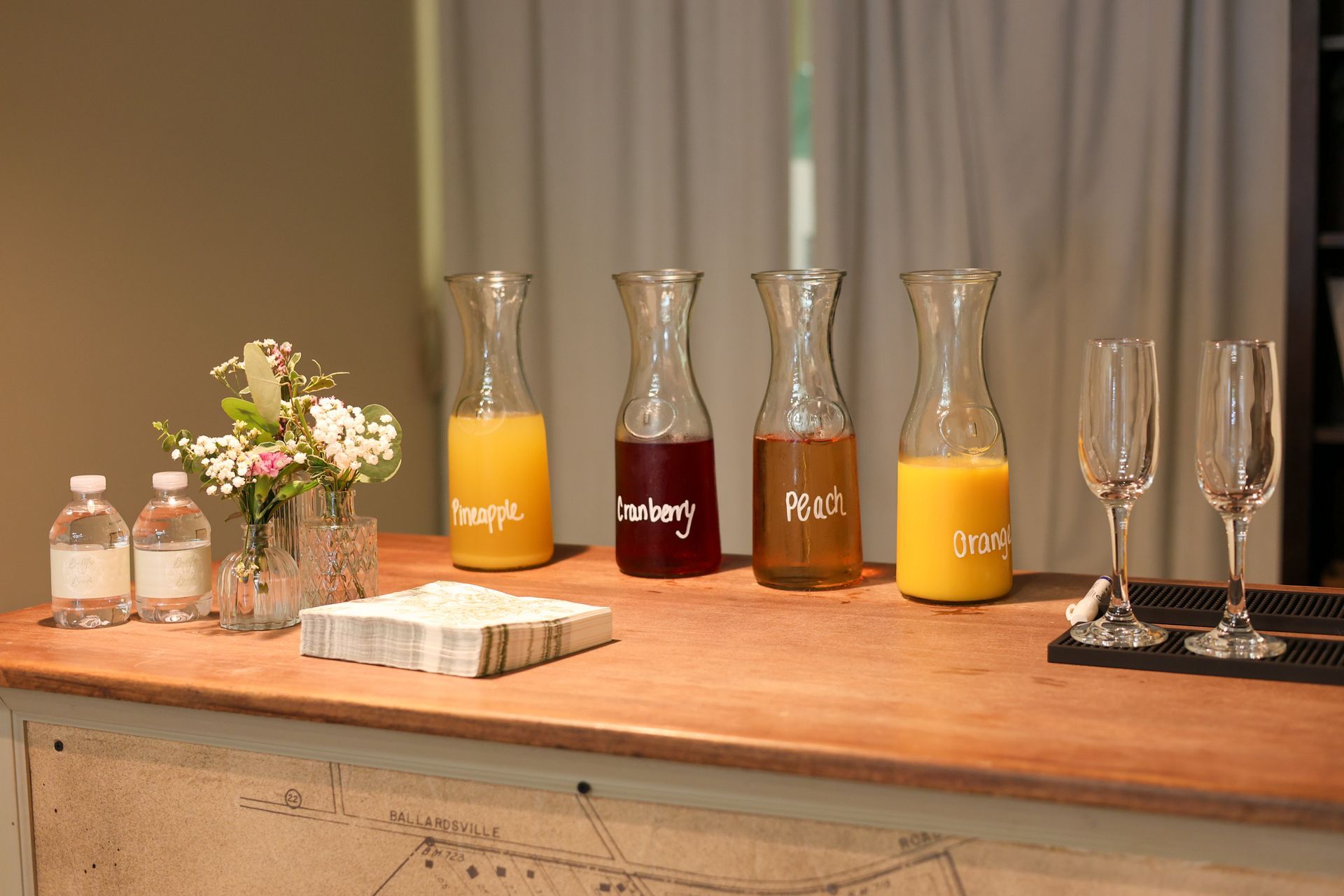 Mimosa bar with juice carafes and champagne flutes