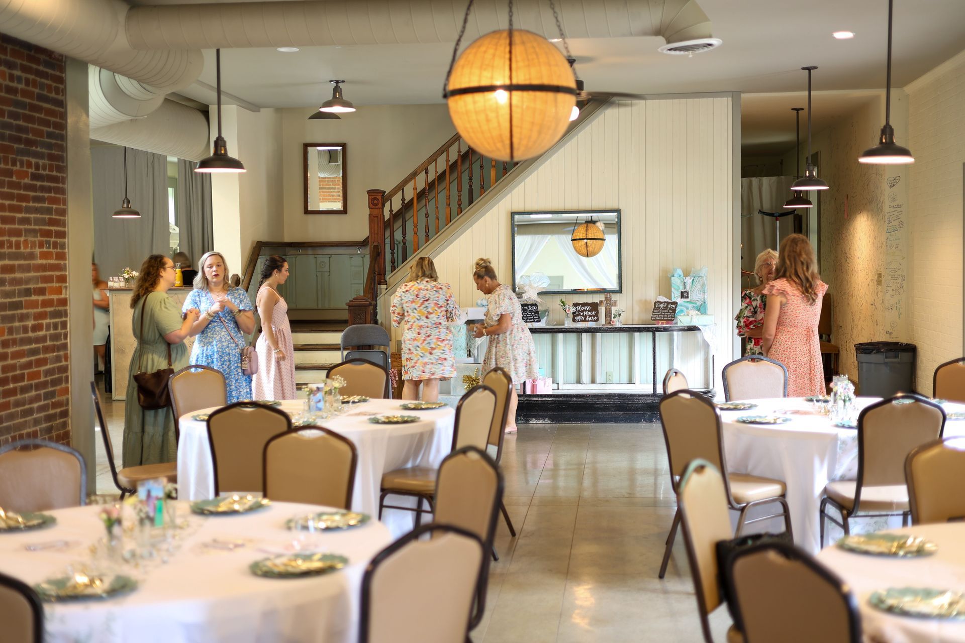 Guests gathered in the historic indoor main hall set with round tables