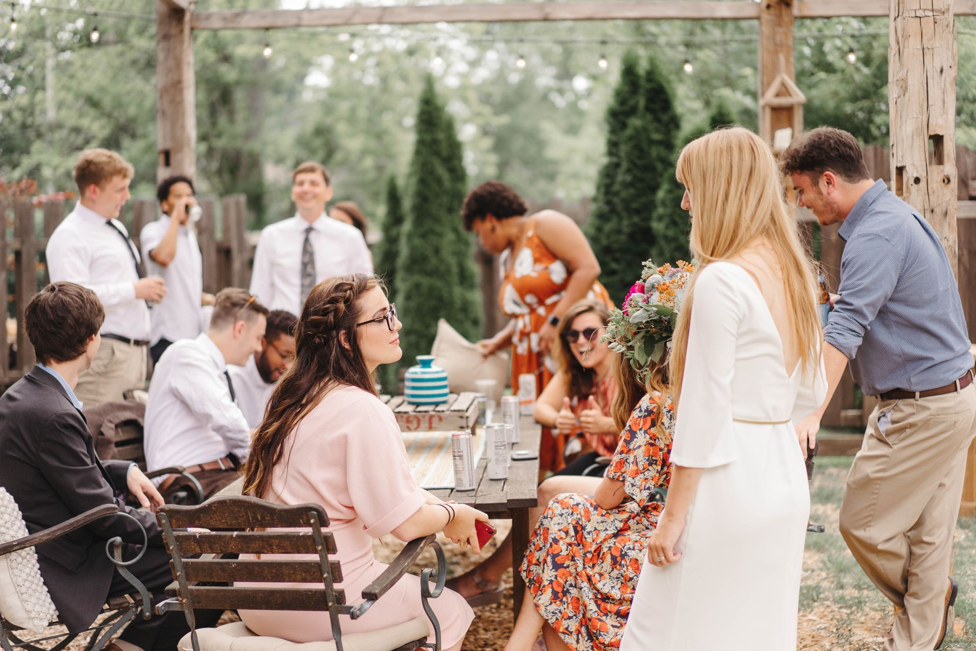 Guests socializing at outdoor garden tables