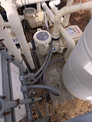 A swimming pool with a lot of pipes and a pump