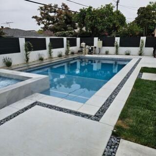 A large swimming pool in the backyard of a house.