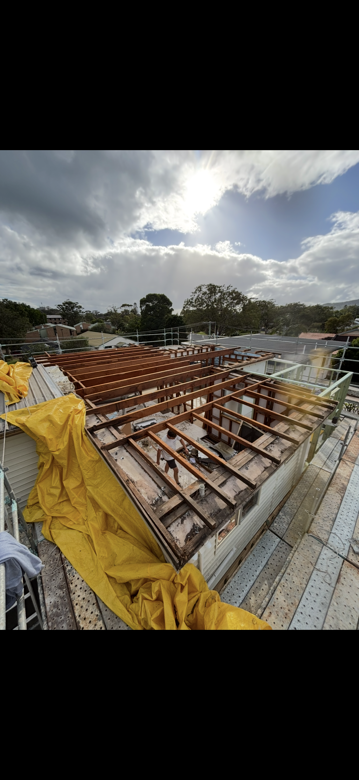 Scaffolding Surrounds a Two-story White House Under Construction, With a Stone Building Visible on the Left — Campbell Built in Anna Bay, NSW