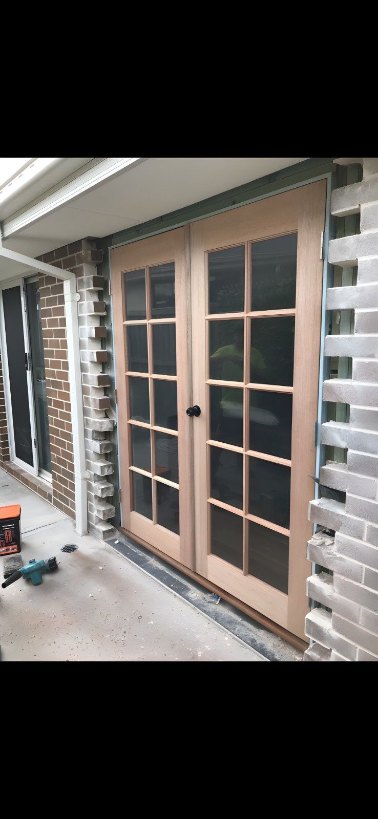 Wooden french doors set in a brick building, black handle — Campbell Built in Nelson Bay, NSW