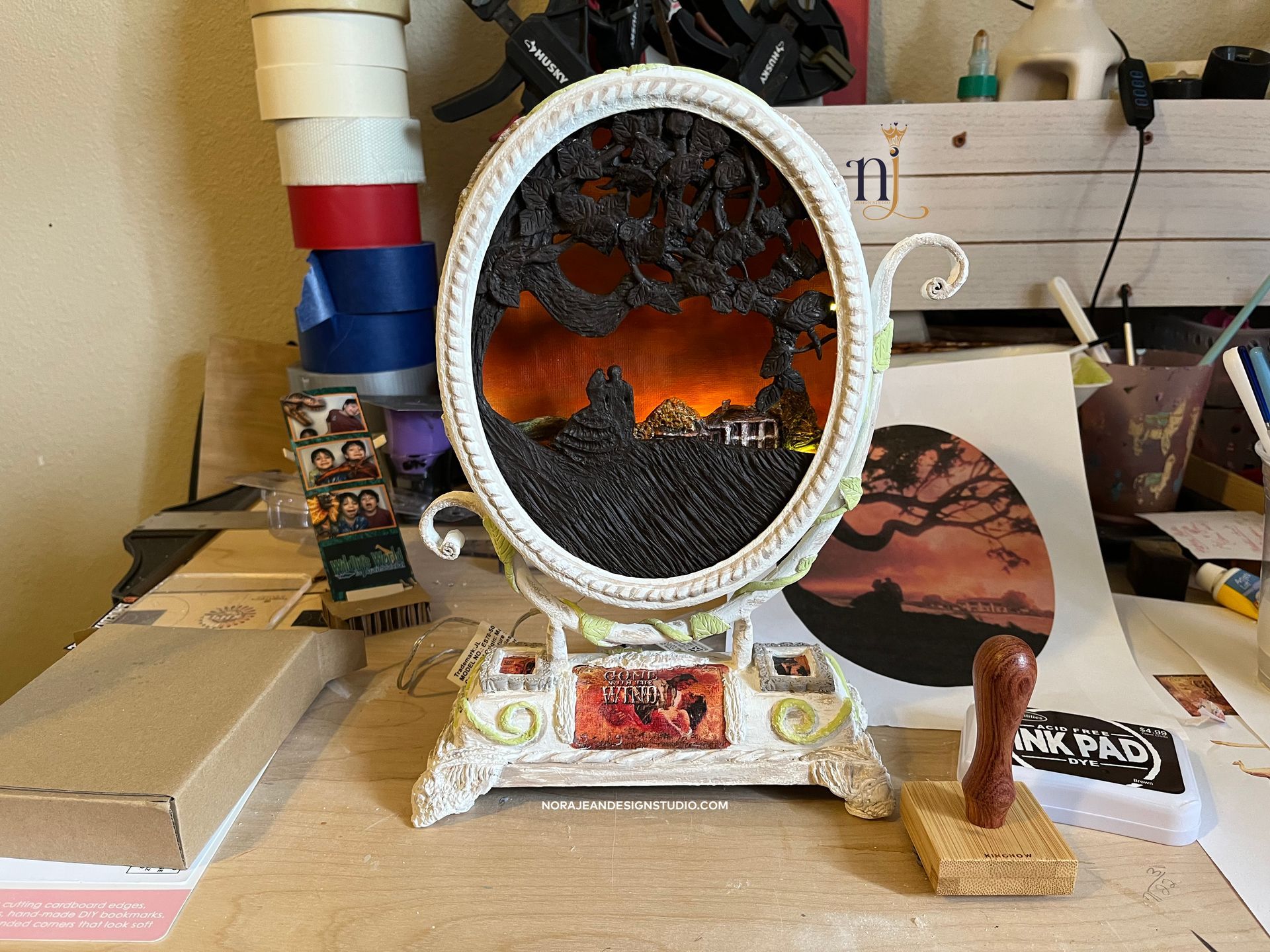 A upcycled clock with a diy canvas inside of it is sitting on a table.