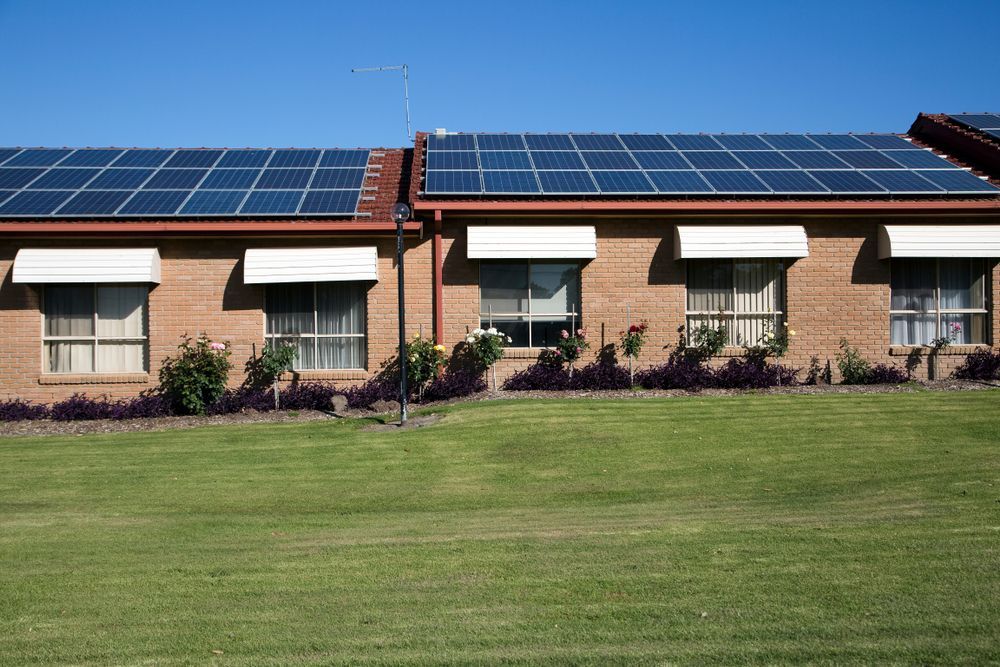 A Brick Building With Solar Panels on the Roof — Macleay Energy Solutions In Macksville, NSW