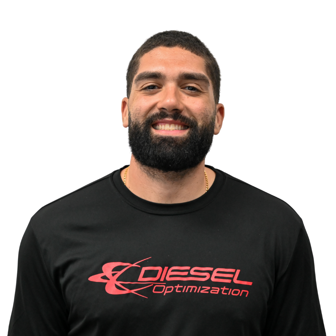 Man with curly hair and a beard, wearing a black t-shirt that says 