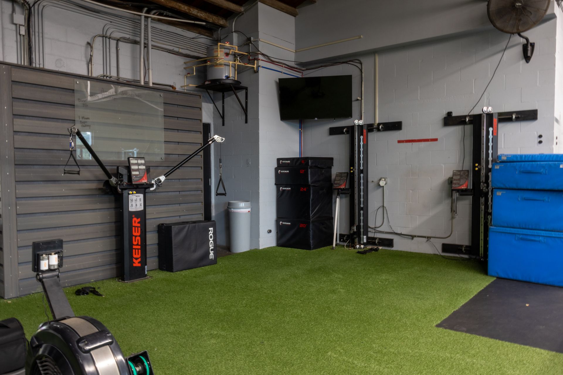 There is a rowing machine in the middle of the room.