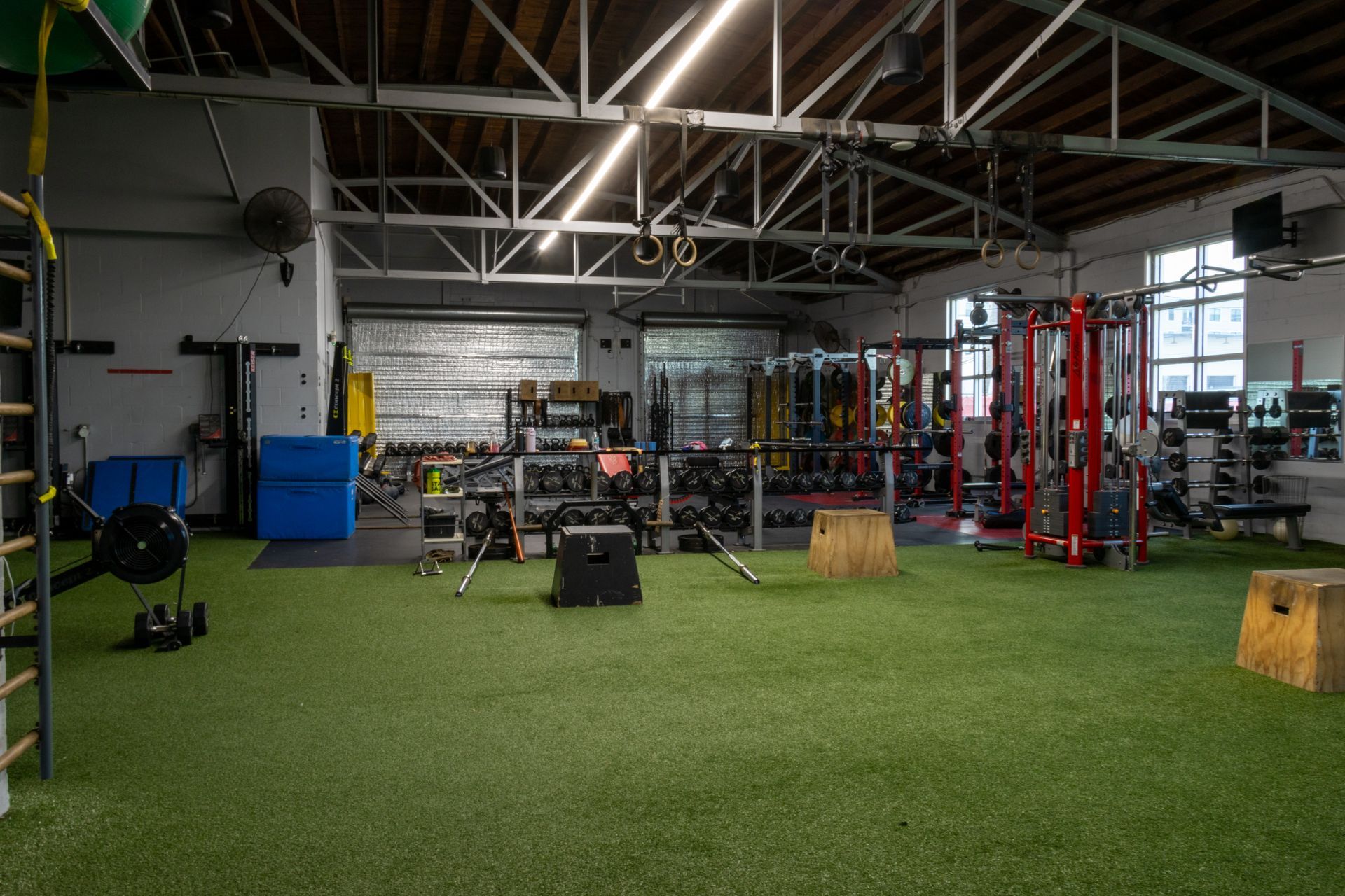 A large gym with a lot of equipment and a lot of grass.