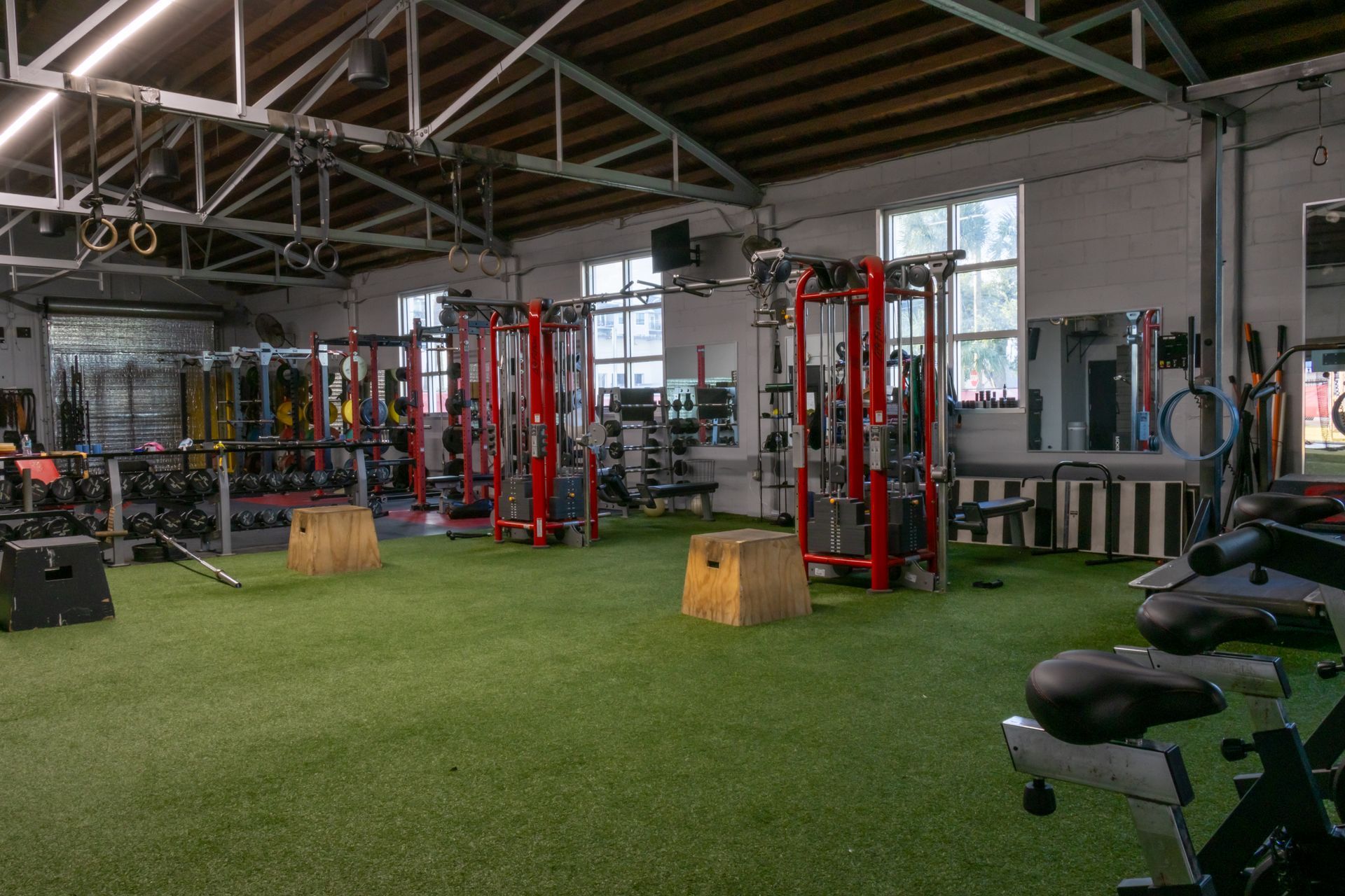 A large gym filled with lots of exercise equipment.