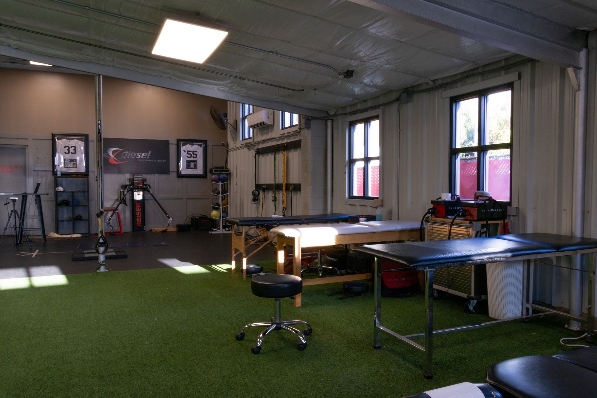 A gym with a lot of tables and chairs in it.