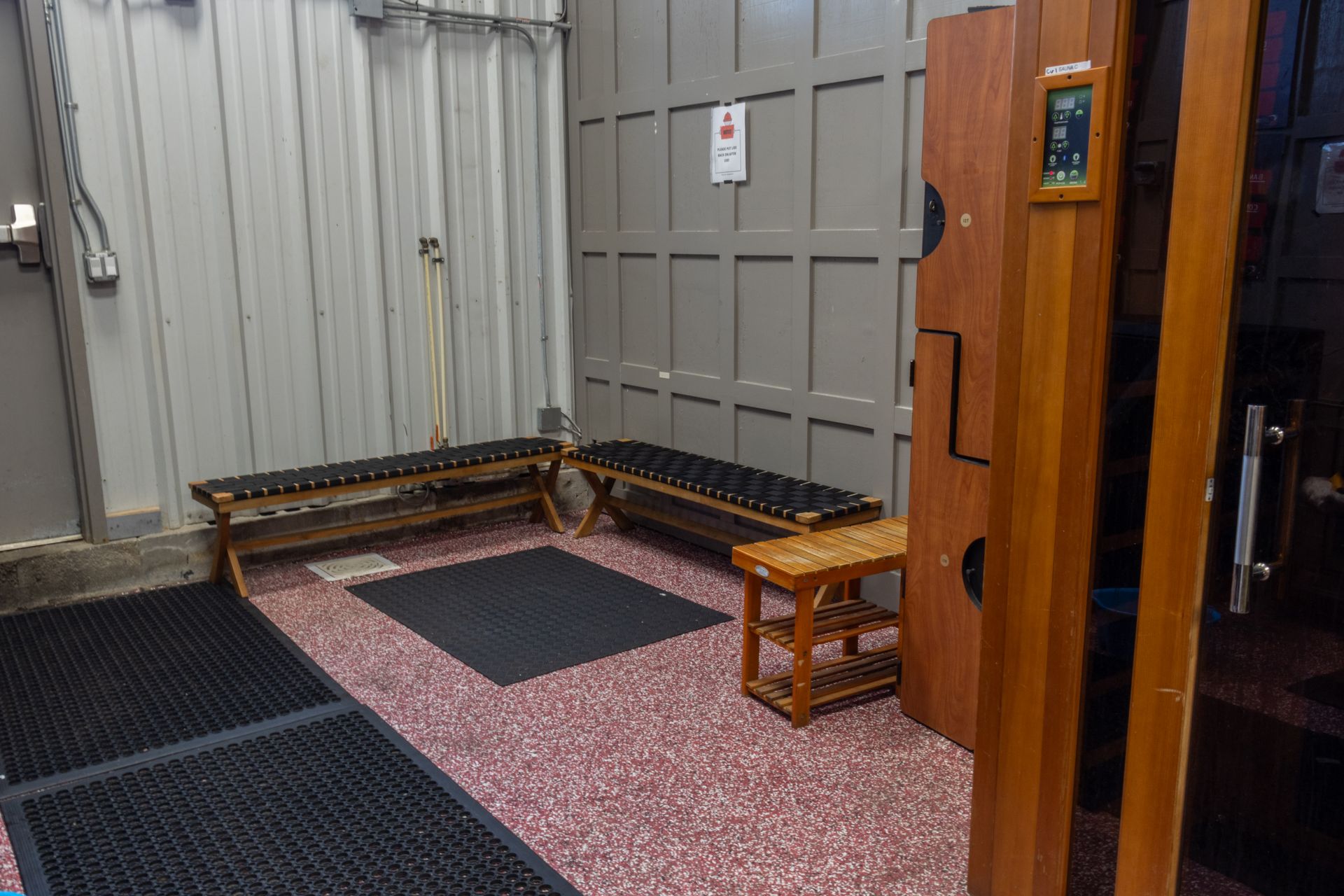 A locker room with a bench and a chair in it