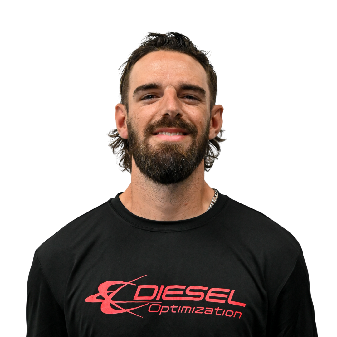 Man with braided hair wearing a dark t-shirt with the words 