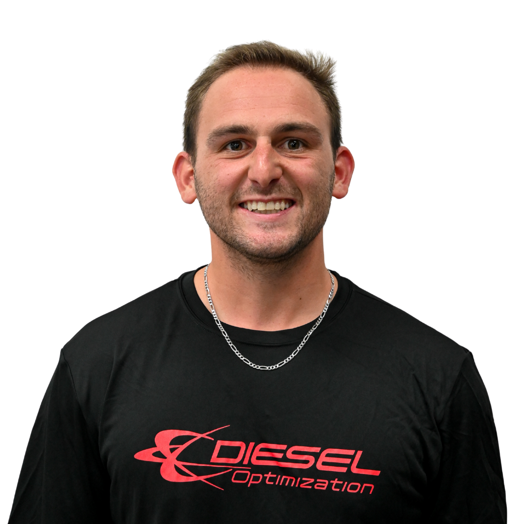 Man with red hair and beard, wearing a dark t-shirt, smiling at the camera against a white background.